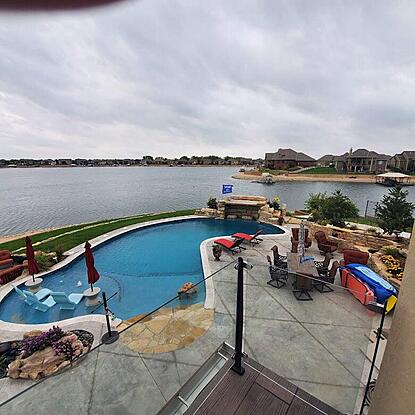 Pool with a lake view and a waterfall