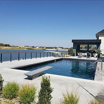 Modern pool with a lakeside view
